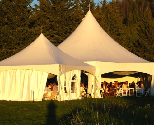 a wedding reception outside under tents