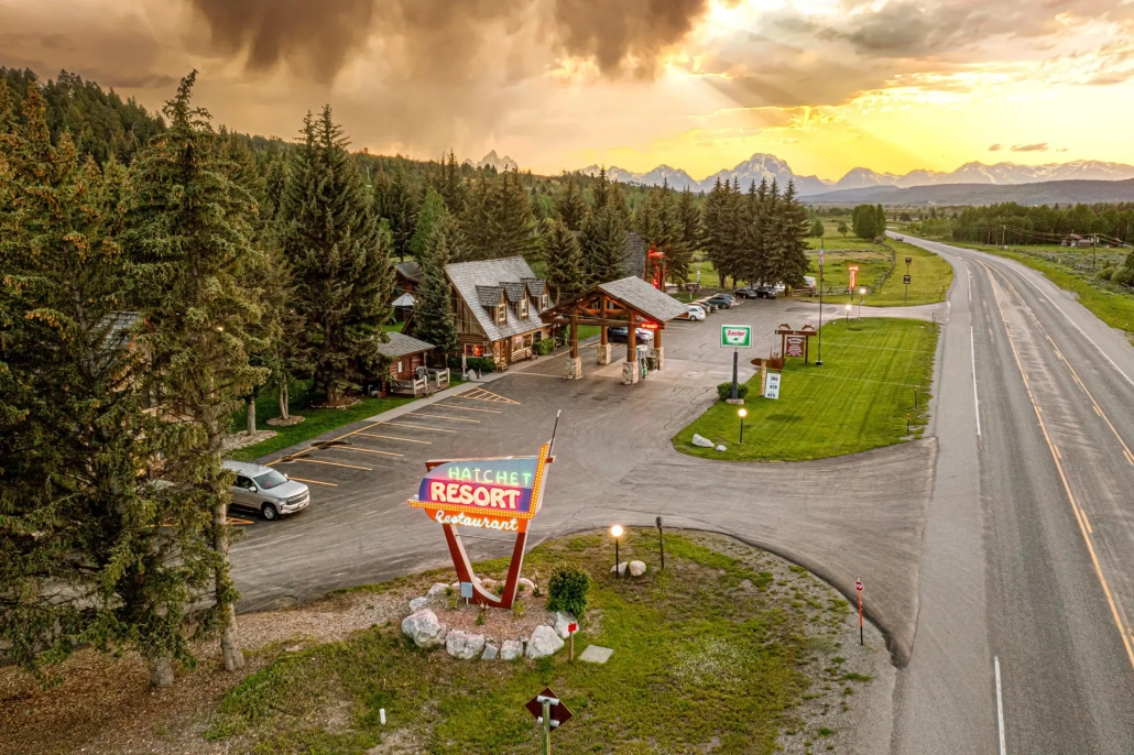 Aerial image of the Hatchet Resort Restaurant sign, parking lot, trees and mountains
