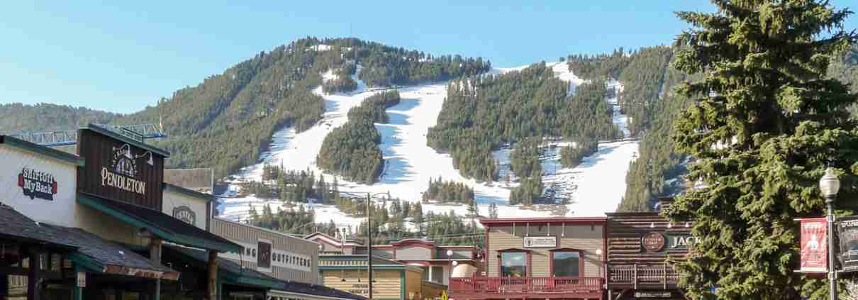 Streets of Jackson Hole with ski slopes at background